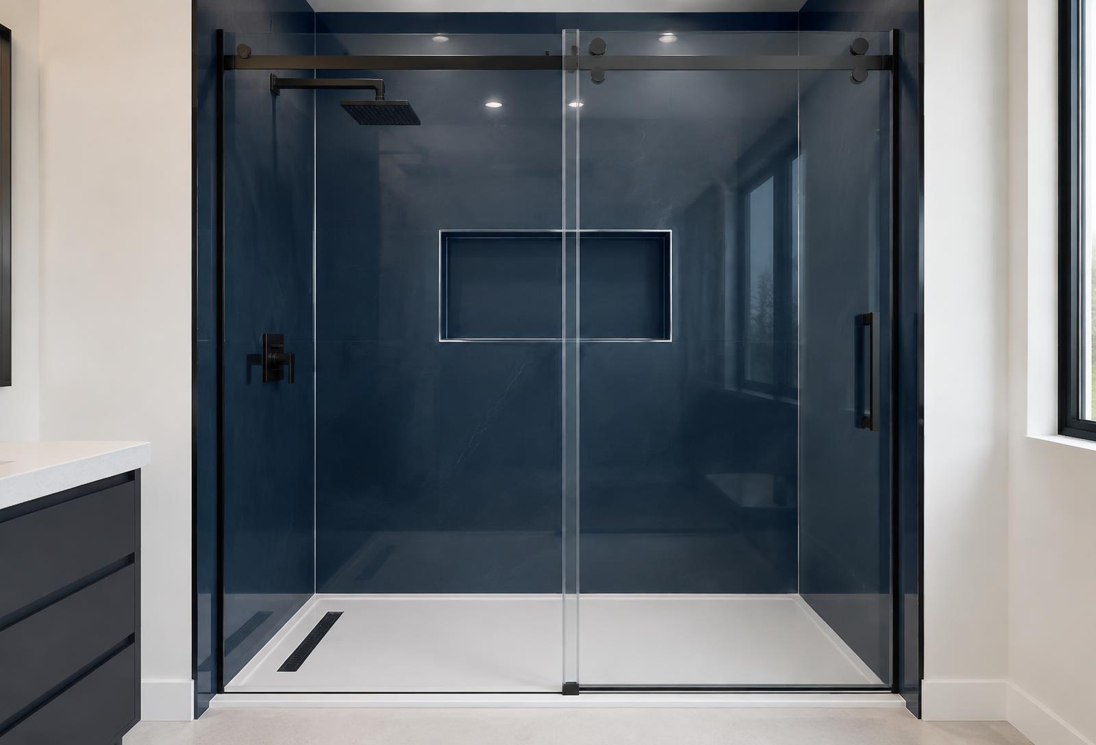 Walk-in shower with deep midnight navy seamless acrylic walls and black-framed sliding glass door