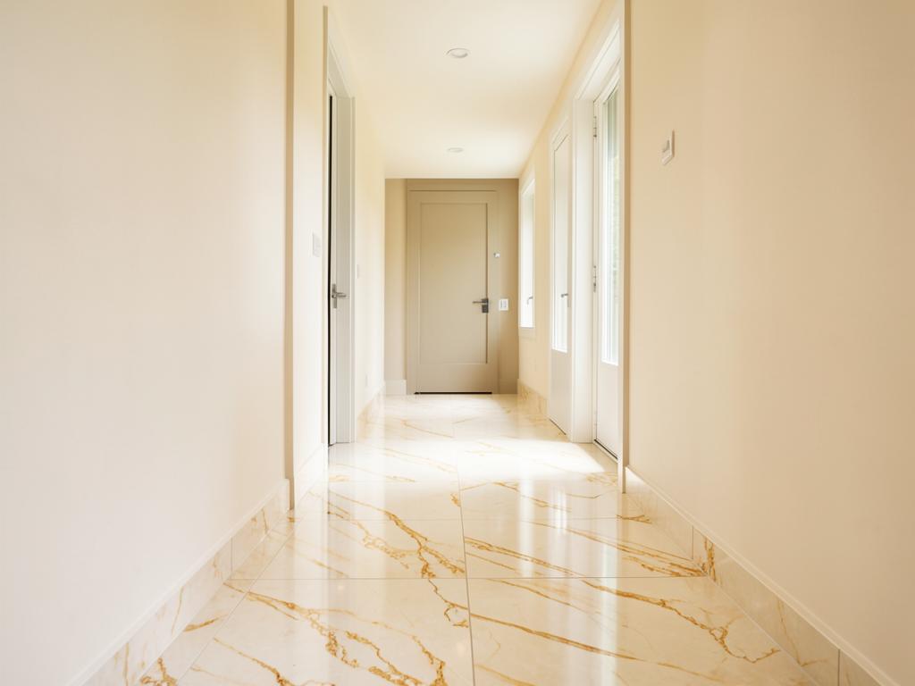 Hallway with warm Calacatta gold marble-look tile flooring